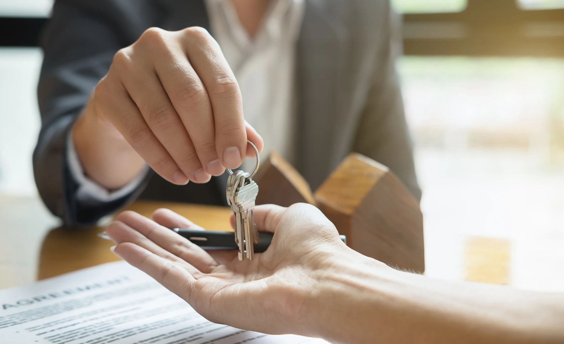 handing keys buying property in the UAE